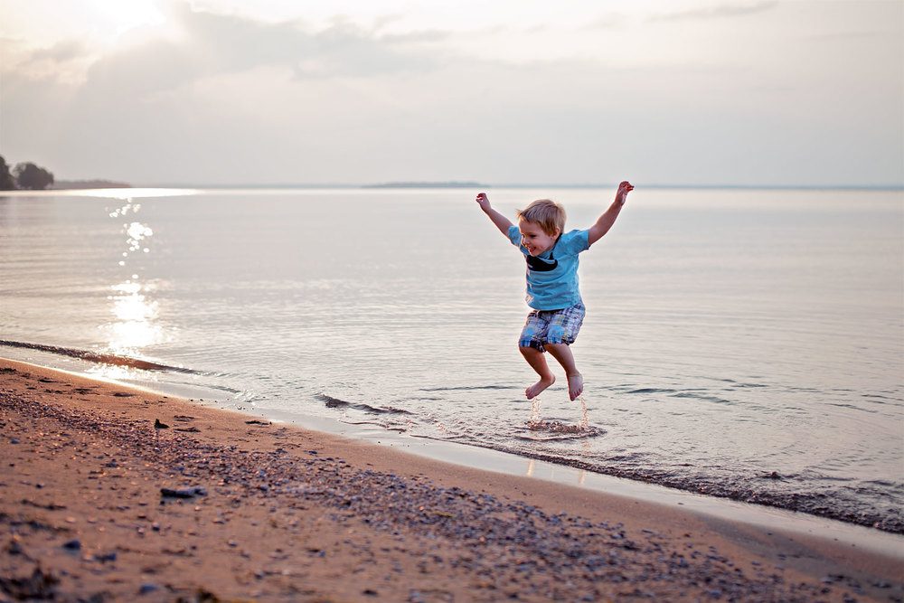 Boy jumping at beach 