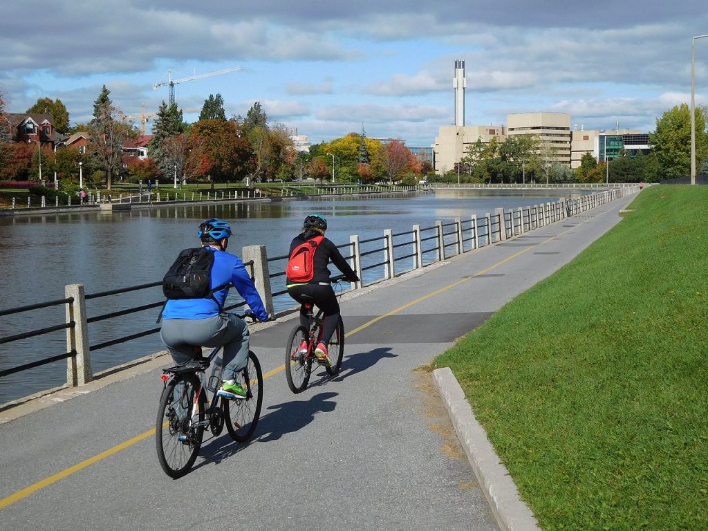 two people cycling by the canal in Ottawa
