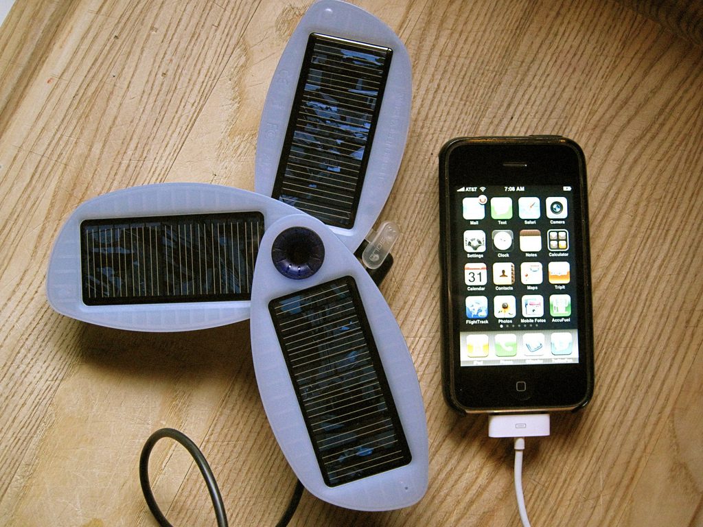 a phone connected to a portable solar charging array