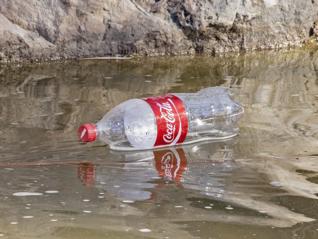 Plastic Coca-Cola bottle floating in water