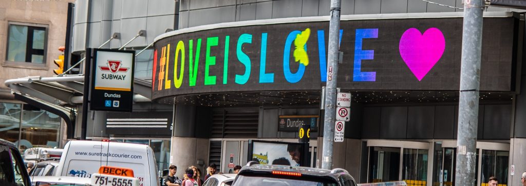 Banner above the subway entrance reads Love is Love in colours