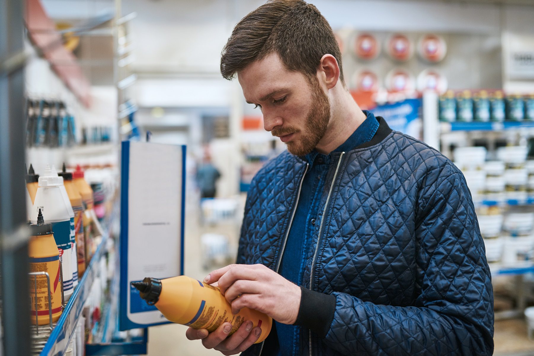 man looking at product label