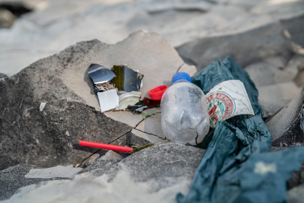 Bits of plastic and a water bottle sat collected from woodbine beach cleanup