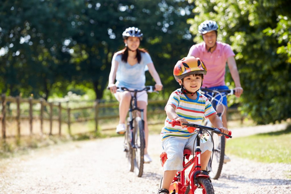 Family cycling outdoors carbon tax is good for Canada