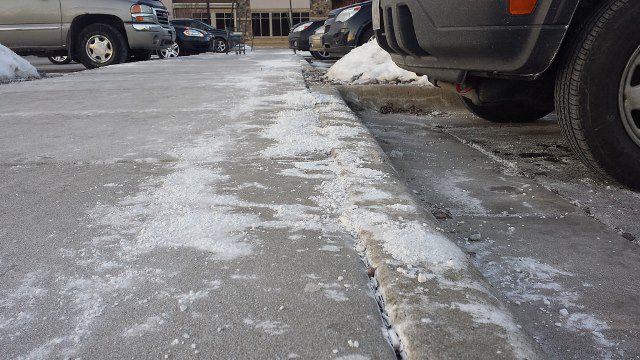 Road salt that has been over applied in a parking lot. 