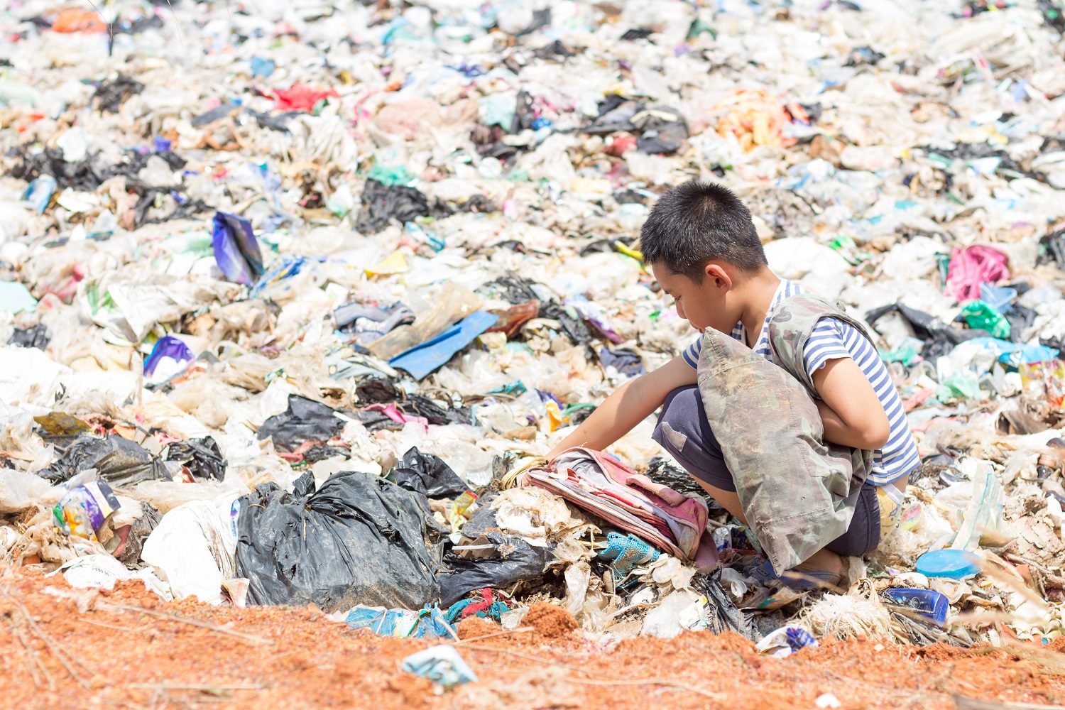 Child in Asia going through plastic pollution