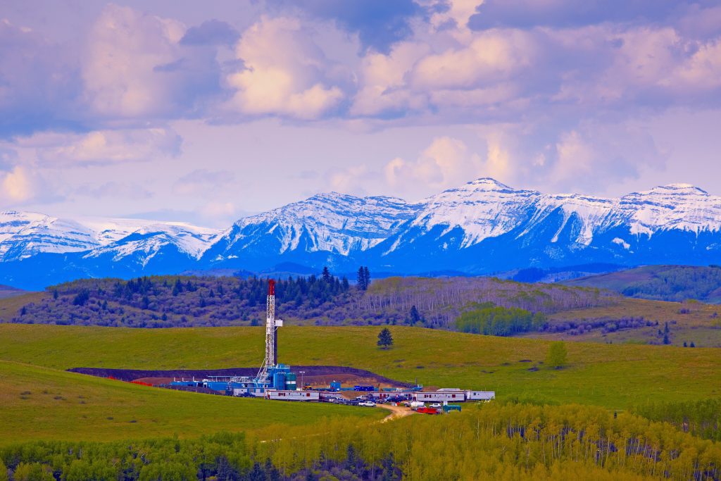 Oil and gas drilling rig in the Rocky Mountain foothills.
