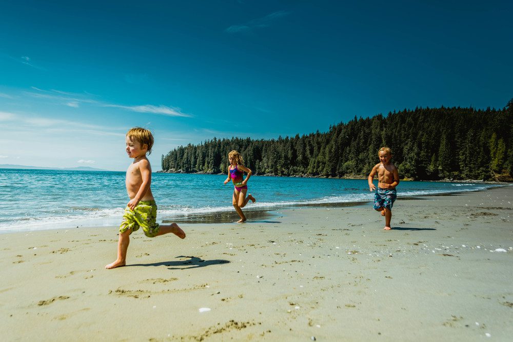kids running along beach
