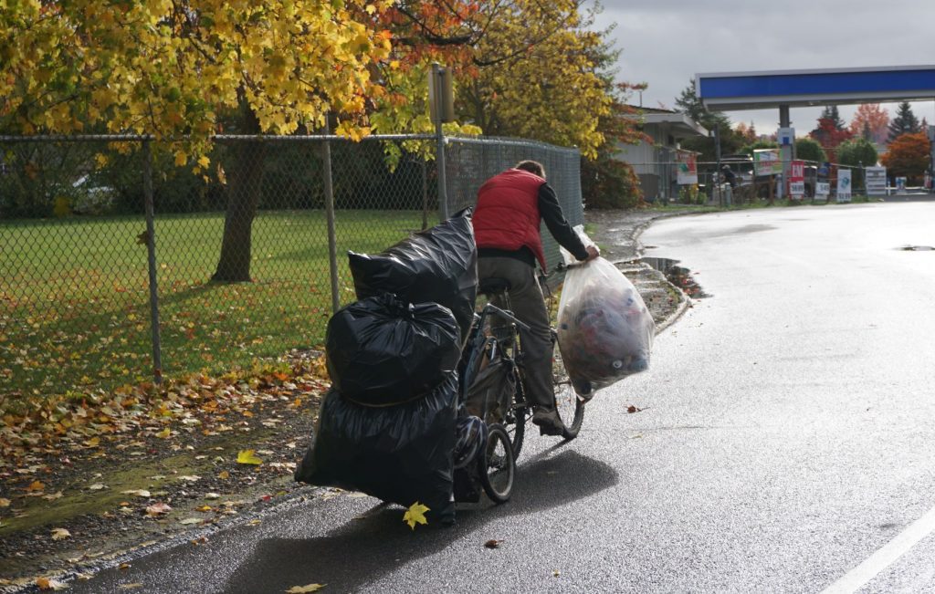 man returning empty bottles and can for recycling