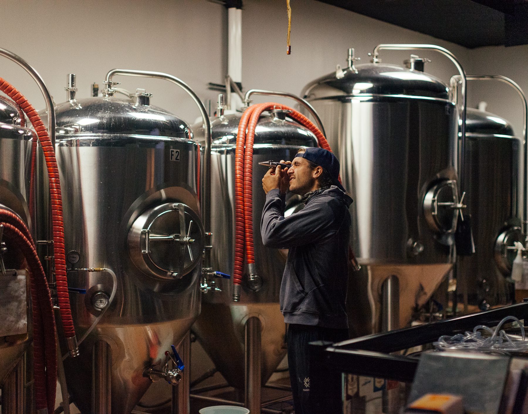 Conrad, one of Fred's four children, manages the brewery.  Here he uses a refractometer - a tool to measure the projected alcohol content of the beer. 