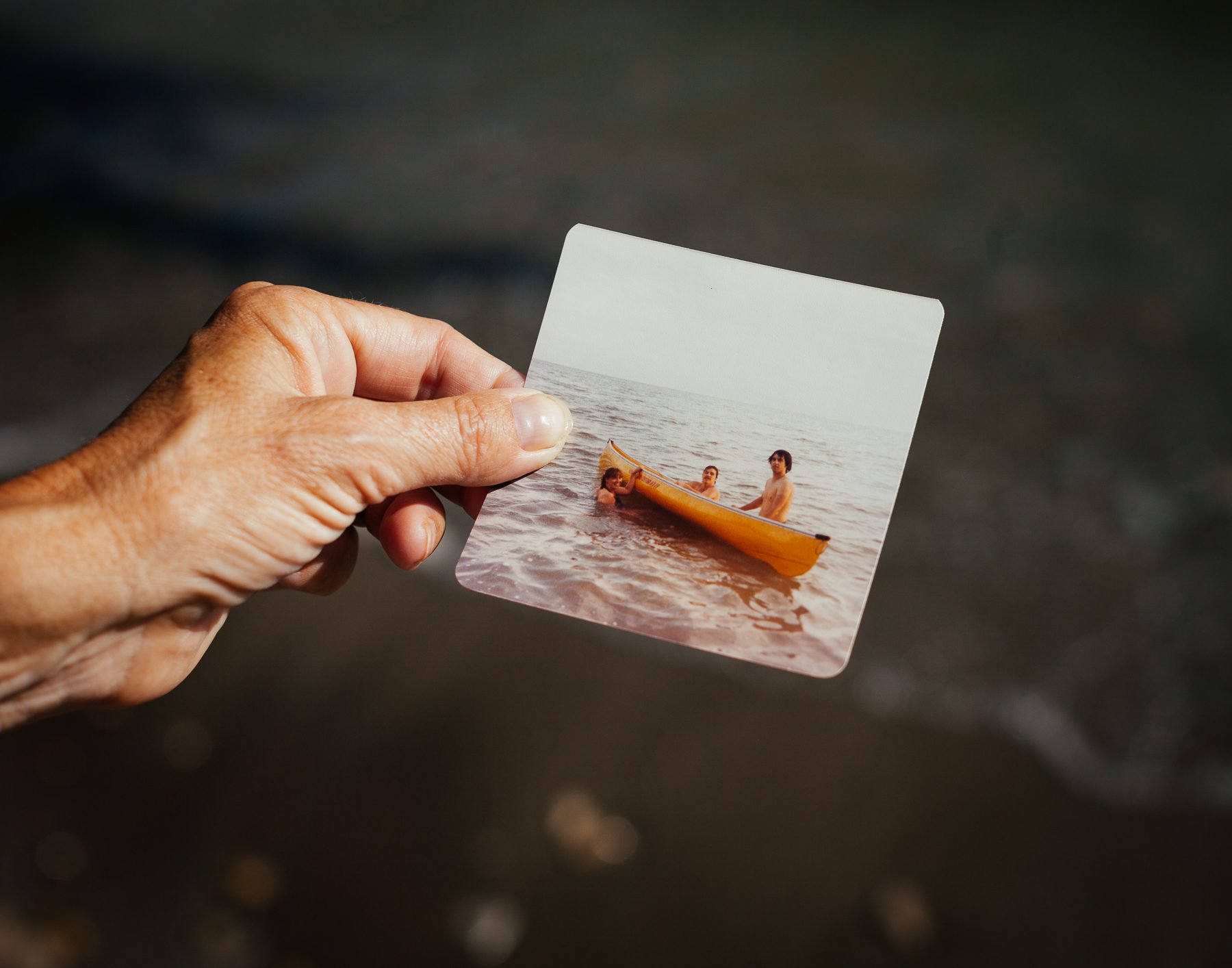 Sandra holds a photograph she took on her honeymoon. In it are her husband Joe, a cousin and the cousin’s fiancée on Holiday Beach (a favourite spot from Joe’s childhood). Sandra explains how this was when she started to fall in love with the Great Lakes