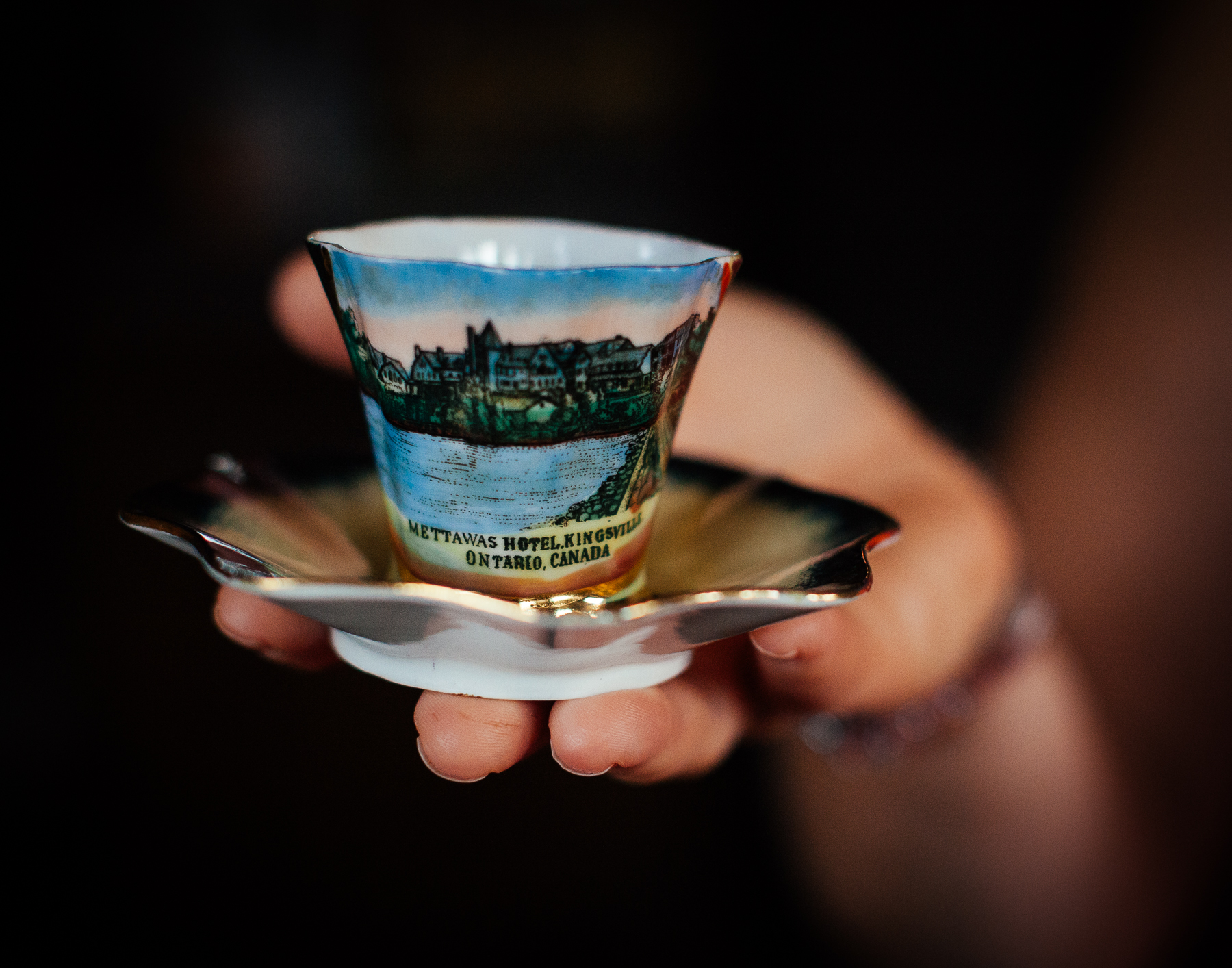 Janet, Anthony’s wife, holds a teacup from the Mettawas Resort 