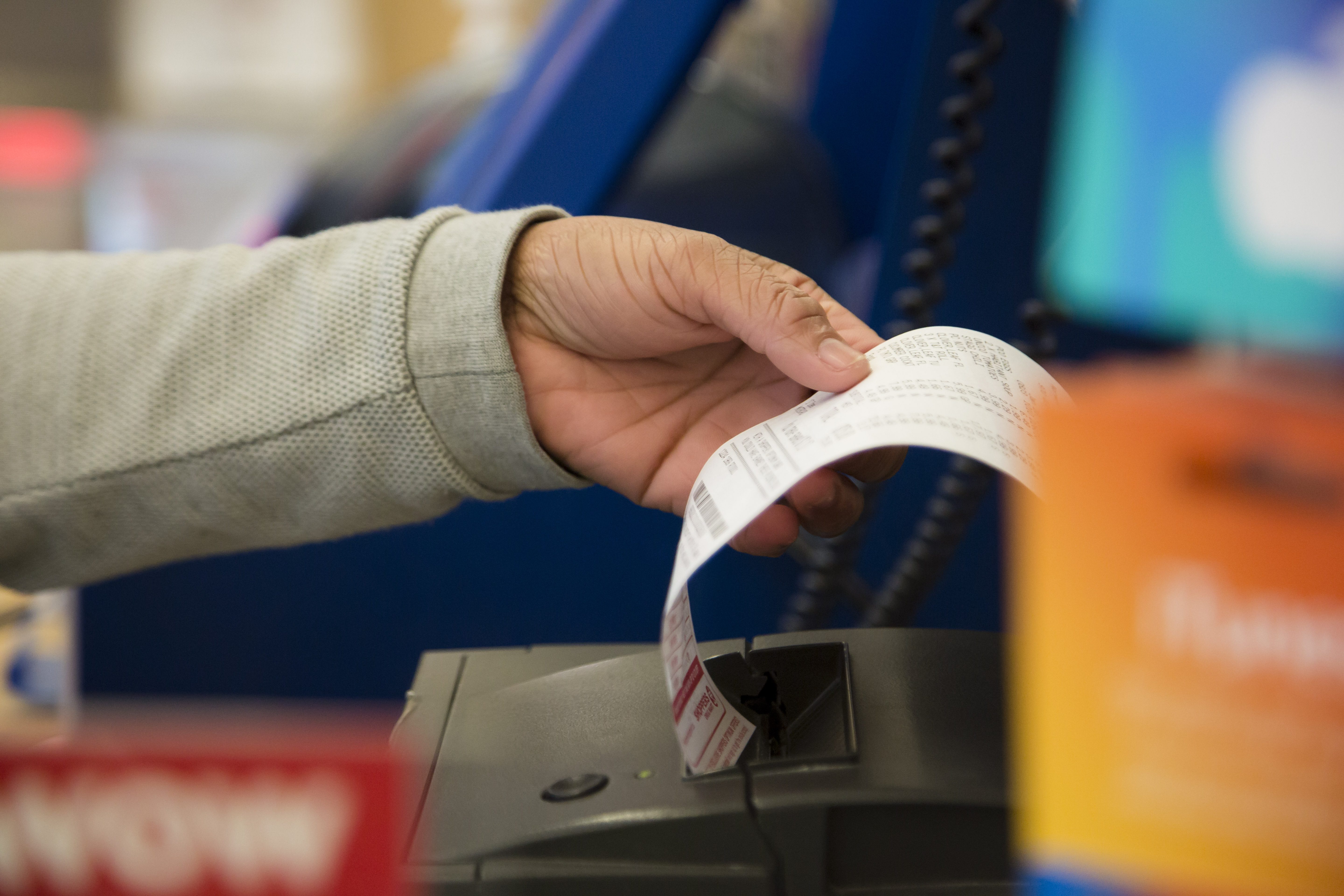 Loblaw cashier handling a receipt