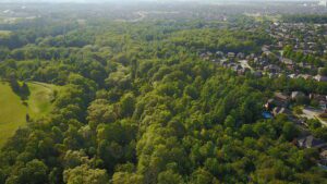 aerial shot of a suburb encroaching on a forested area