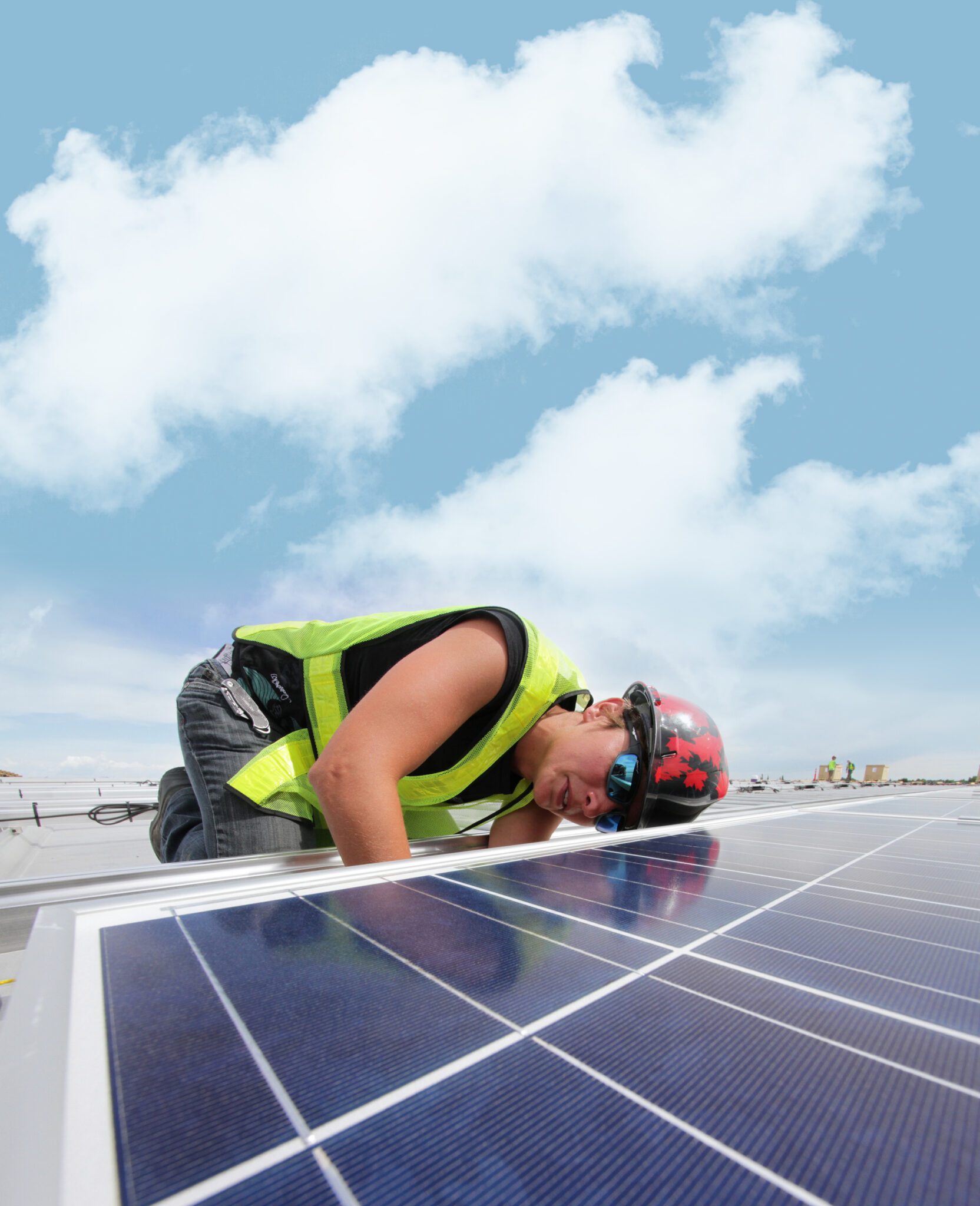 Woman installing solar panels hearing a vest and helmet