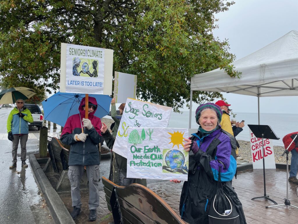 Seniors holding signs about the importance of climate action