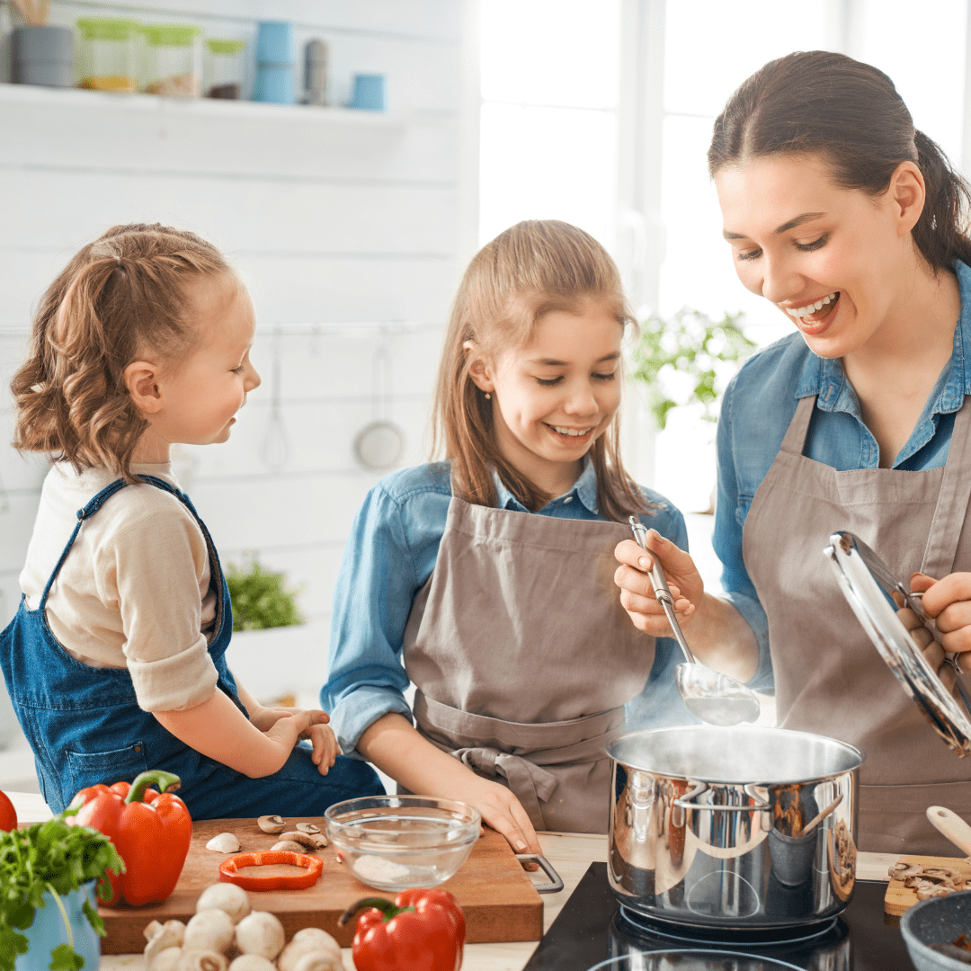 Mom and daughters cooking a healthy meal.