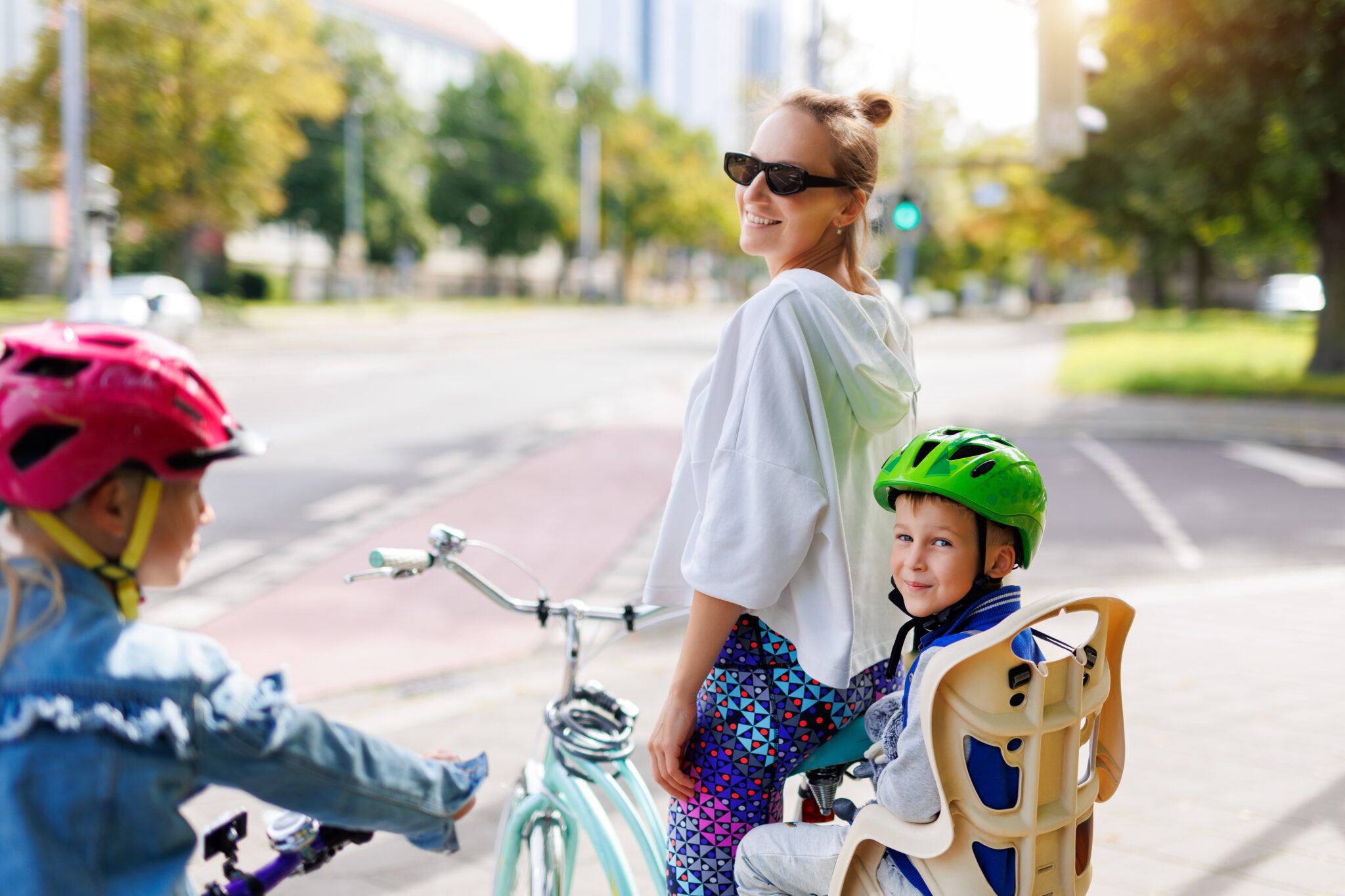 Mother and two children cycling together