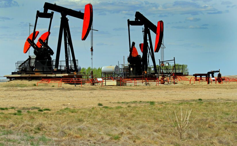 Pumps being oil or gas to the surface in Albera. The landscape includes many of these mechanical beasts on the praires.