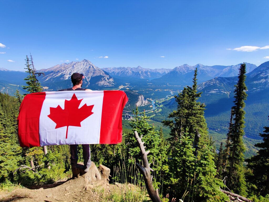 Canadian Flag on Man's Back in wilderness