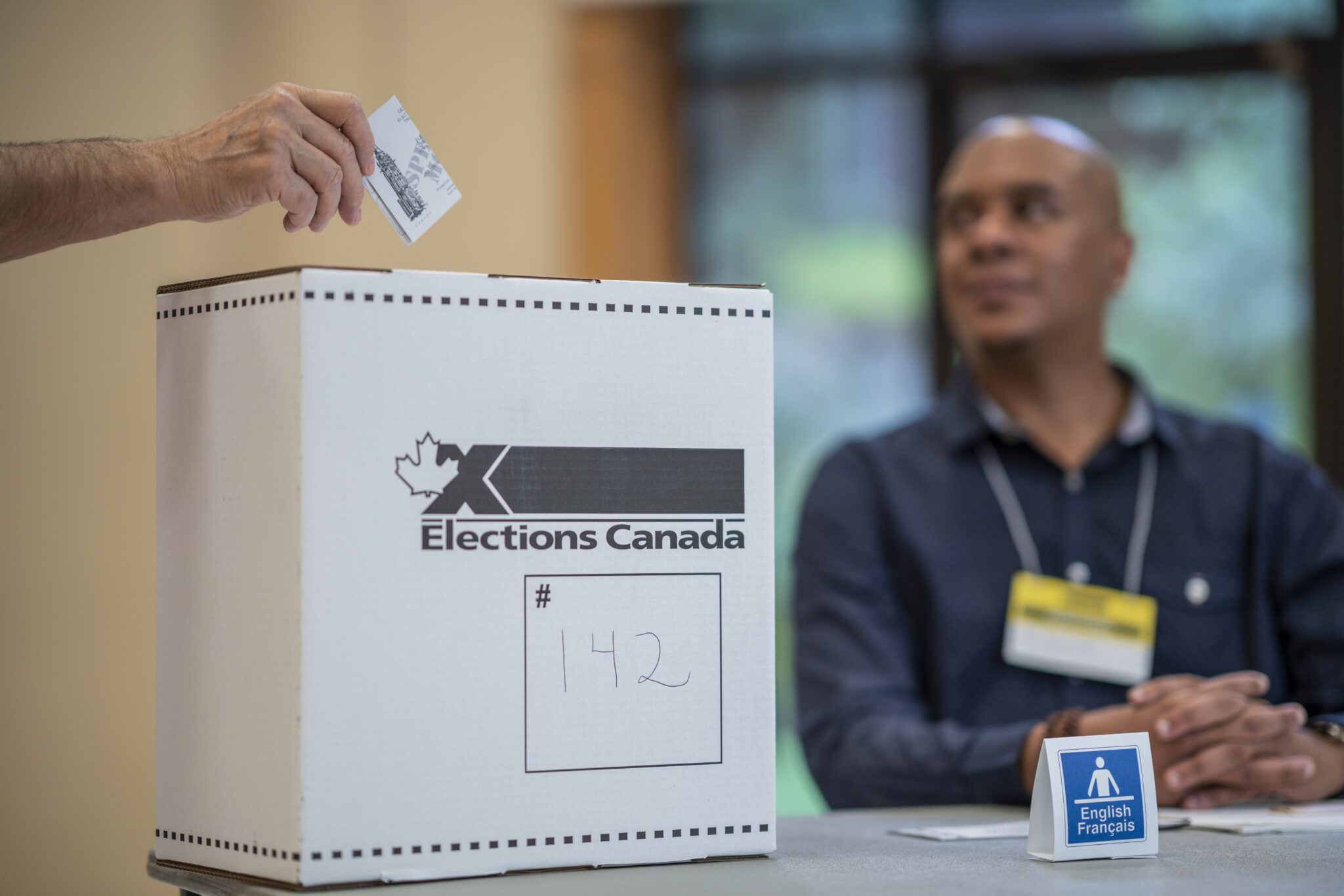 Person casting ballot in Canadian election