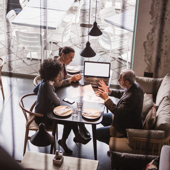 Businesspeople Having Meeting In A Restaurant.